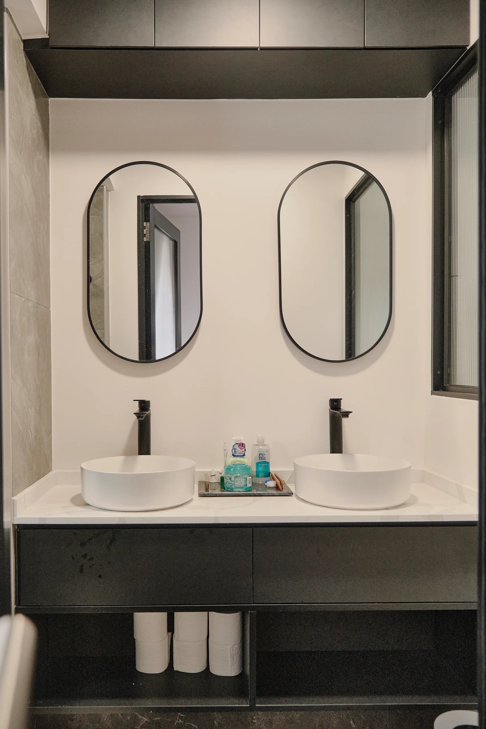 2 sinks and 2 mirrors with an overhead storage cabinet