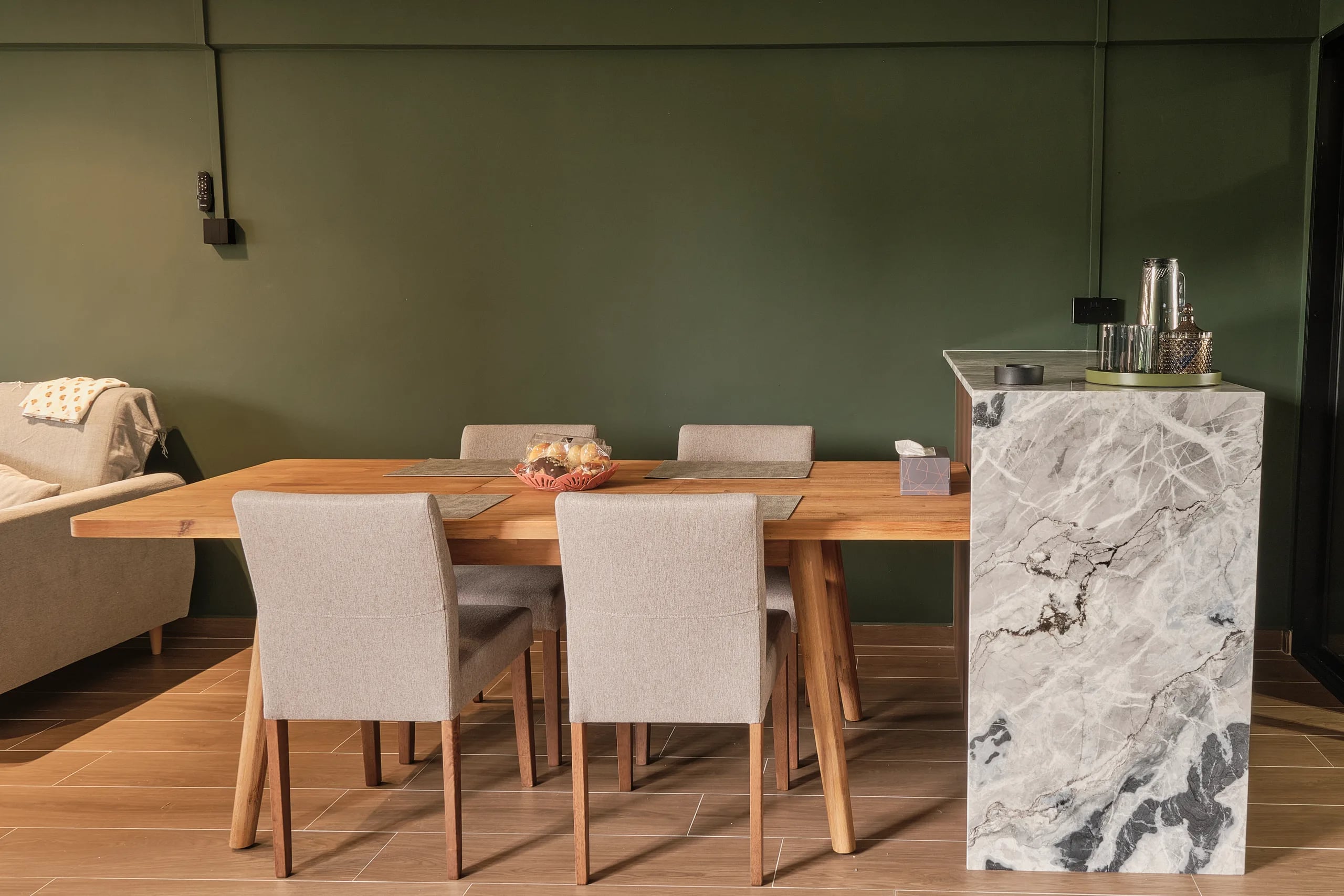 A dining table joined to a countertop with a waterfall edge with sintered stone