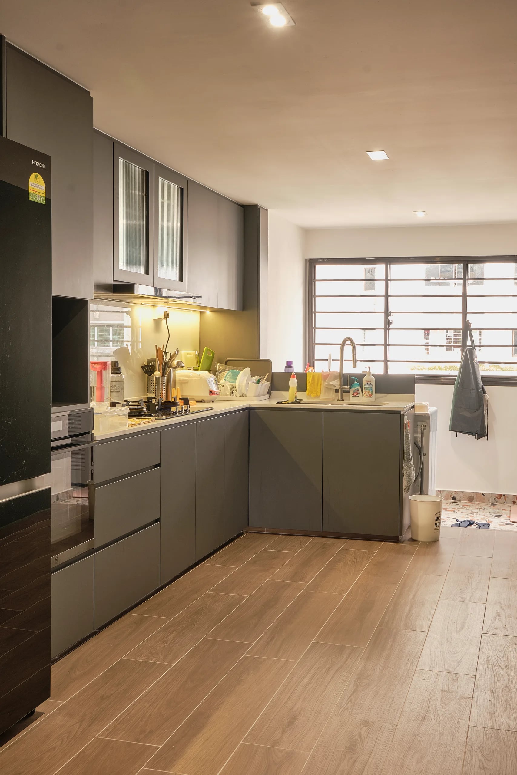 open concept kitchen with sage green laminates in an l-shape