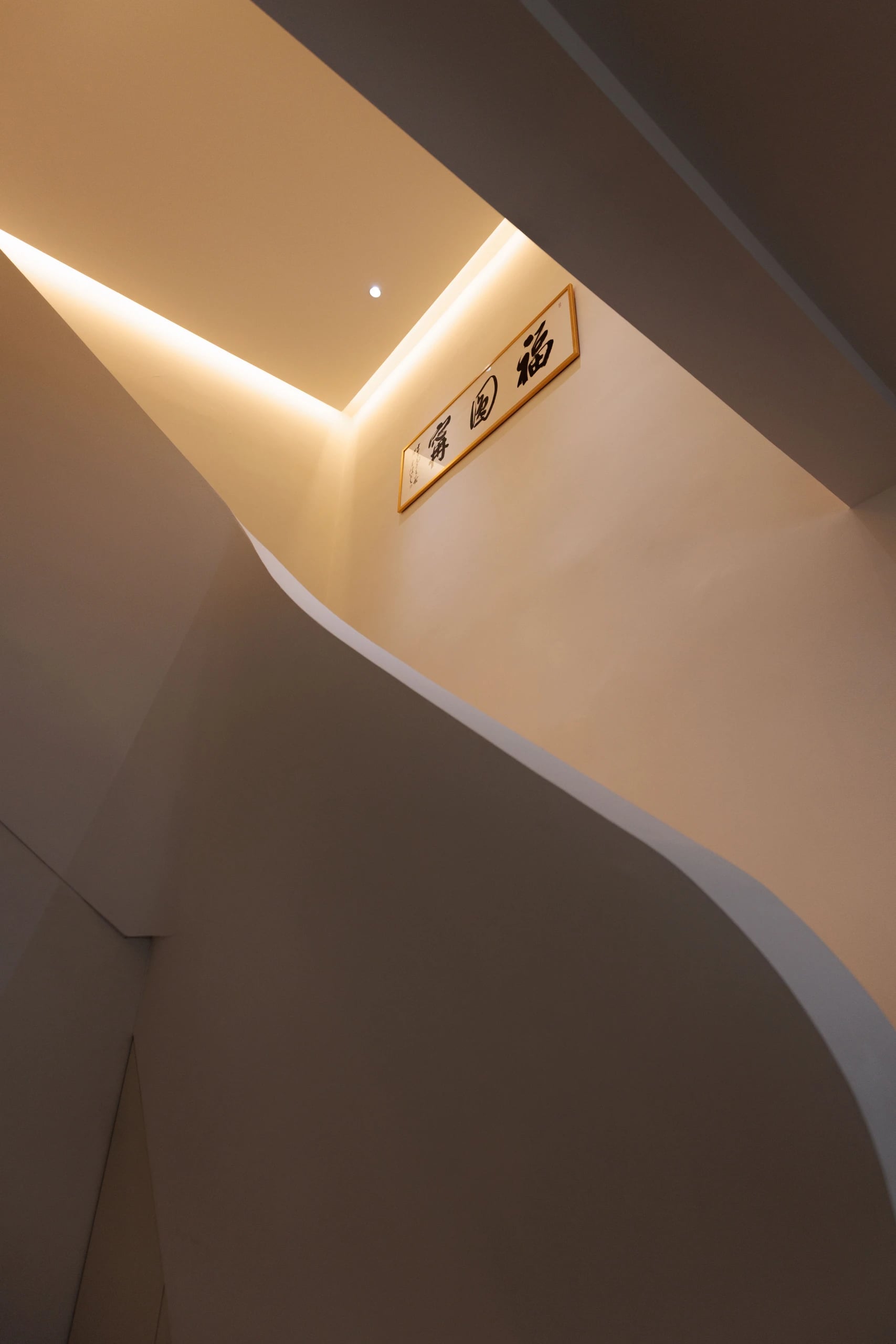Stairs with curve railing and cove light